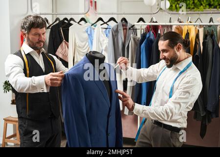 Two tailors focused on working in studio Stock Photo