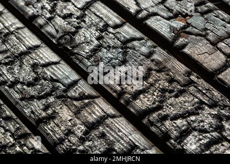 Black wooden board texture, close up. BBQ background. Burnt wooden Board texture. Burned scratched hardwood surface. Smoking wood plank background. Bu Stock Photo