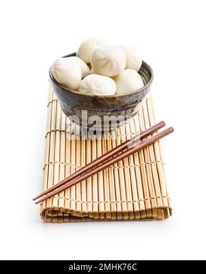Xiaolongbao, traditional steamed dumplings in bowl. Xiao Long Bao buns isolated on the white background. Stock Photo