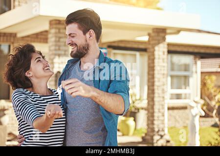 New home, new start. a happy young couple holding the keys to their new home. Stock Photo