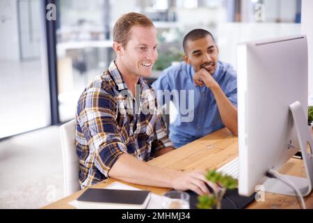 Weve dreamt it, now lets design it. two young designers working together on a computer in an office. Stock Photo