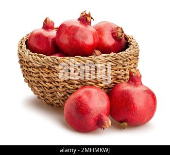 pomegranate in a basket path isolated on white Stock Photo