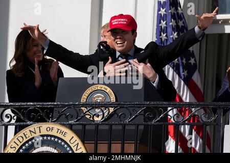 President Donald Trump, left, reacts as Washington Nationals catcher Kurt  Suzuki walks to a podium to speak during an event to honor the 2019 World  Series champion Nationals at the White House