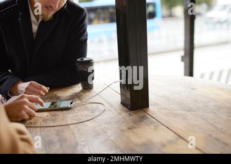 Mid section of people using cell phone Stock Photo