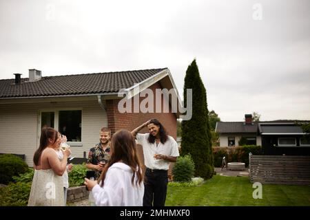 Smiling friends talking in garden Stock Photo