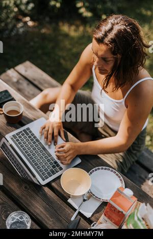 High angle view of woman using laptop Stock Photo