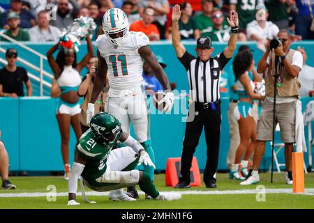 New York Jets running back LaDainian Tomlinson (21) celebrates his game-winning  two-yard touchdown run with Denver Broncos cornerback Nate Jones watching  in the fourth quarter at Invesco Field at Mile High on