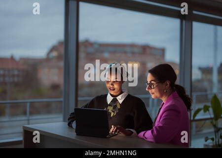 Women working together on laptop Stock Photo