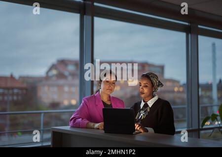 Women working together on laptop Stock Photo