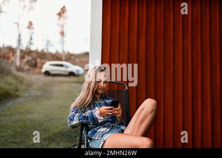 Young woman using cell phone Stock Photo