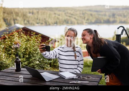Smiling women taking selfie Stock Photo