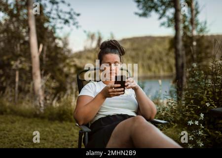 Young woman using cell phone Stock Photo