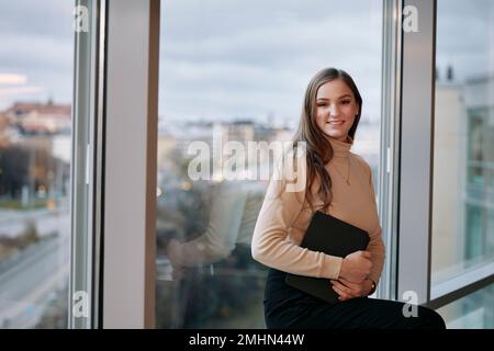 Portrait of smiling businesswoman holding tablet Stock Photo