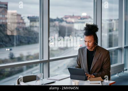 Young businessman using tablet in office Stock Photo