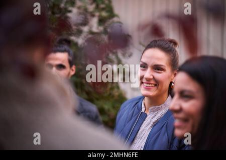 Smiling friends talking in garden Stock Photo