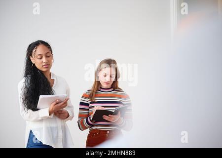 Businesswomen making notes in office Stock Photo
