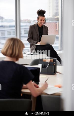 Business people working on laptops in office Stock Photo