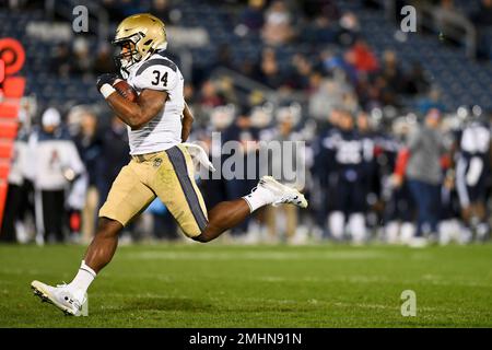 Navy fullback Jamale Carothers (34) runs through the Tulane defense ...