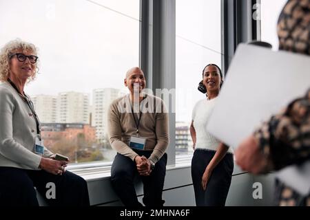 Business people talking during coffee break in office Stock Photo