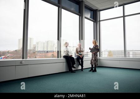 Business people talking during coffee break in office Stock Photo