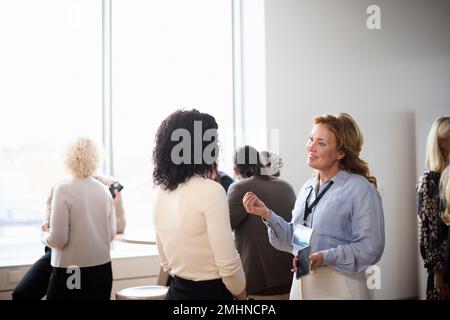 Businesswomen talking during coffee break Stock Photo