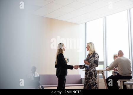 Businesswomen talking during coffee break Stock Photo