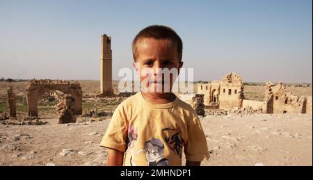 Portrait of local 6 year old child  standing in front of Harran ancient city Harran -Urfa-Turkey Stock Photo