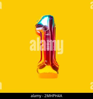 Rainbow foil balloon number, digit one. Top view. Colored numeral on yellow background. Stock Photo