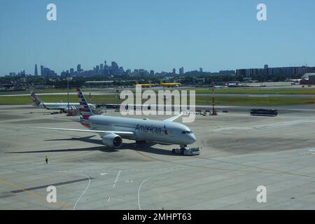 January 2023, American Airways plane at Sydney Kingsford Smith airport with Sydney city skyline in the distance. Stock Photo