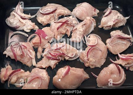 Raw meat on the tray in the oven . Diced Raw Meat for Cooking Stock Photo