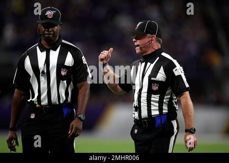 Officials, from left to right, replay official Kevin Brown, down judge  Michael Dolce, field judge Jimmy Buchanan, umpire Bryan Neale, referee  Shawn Smith, back judge Dino Paganelli, line judge Mark Steinkerchner and