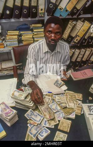Zambia, Mangu. Bookkeeper is counting the cash money . Stock Photo