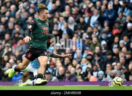 Aston Villa's Jack Grealish, left, and Manchester City's Raheem Sterling challenge for the ball during the English Premier League soccer match between Manchester City and Aston Villa at Etihad stadium in Manchester, England, Saturday, Oct. 26, 2019. (AP Photo/Rui Vieira)