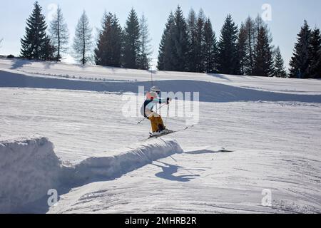 Happy family, skiing in Italy on a sunny day, kids and adults skiing together. Family vacation Stock Photo