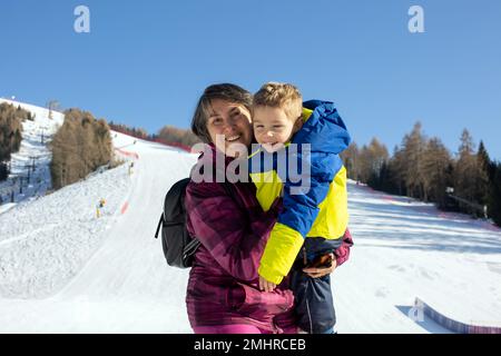 Happy family, skiing in Italy on a sunny day, kids and adults skiing together. Family vacation Stock Photo