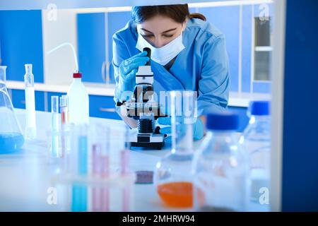 Scientist working with microscope indoors. Laboratory analysis Stock Photo