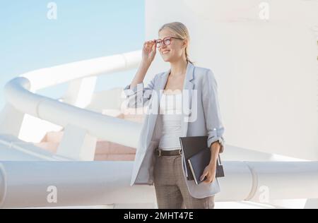 Young blond businesswoman posing in a modern building. Stock Photo