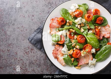 Salad Aveyronnaise is a classic dish of the Aveyron combining three of its principal ingredients bacon, walnuts and Roquefort closeup on the plate on Stock Photo
