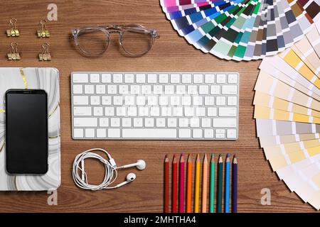 Flat lay composition with wireless keyboard on wooden table. Designer's workplace Stock Photo