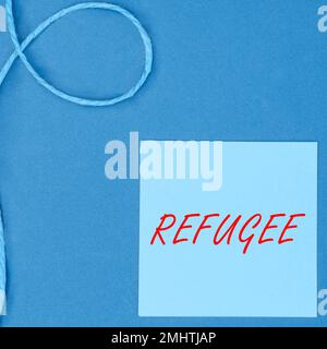Inspiration showing sign Refugee. Word Written on refer to movements of large groups of displaced people Stock Photo