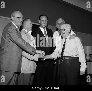 George Halas, owner-president of the Chicago Bears, seems to have some  interested listeners in Jack Jennings, center, of the Chicago Cardinals,  and Chuck Bednarik, right, of the Philadelphia Eagles, as they wait