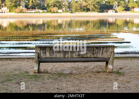 cement bench at the edge of oyster farming installed in the hossegor canal Stock Photo