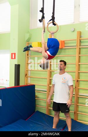 MOSCOW, RUSSIA-DEC 18, 2022: athlete sport ring strong boy health champion gymnast male exercise balance sportsman Stock Photo