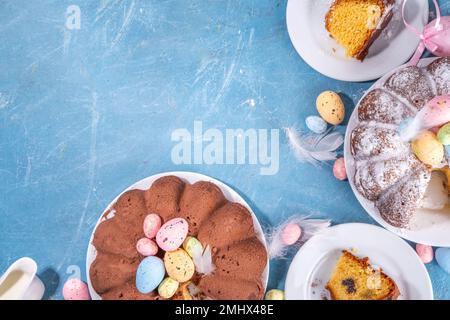 Traditional cake for Easter. Chocolate and vanilla Easter round cake with chocolate and sugar powder sprinkles, colorful Easter eggs, spring flowers, Stock Photo