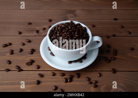roasted coffee beans in coffee cup on table Stock Photo
