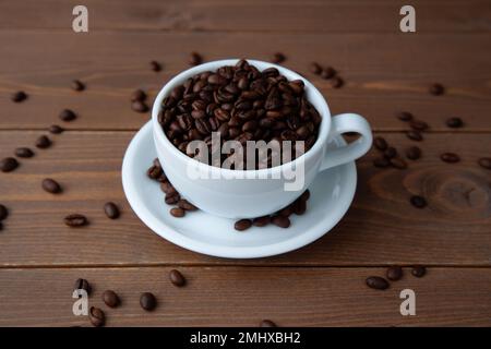 roasted coffee beans in coffee cup on table Stock Photo
