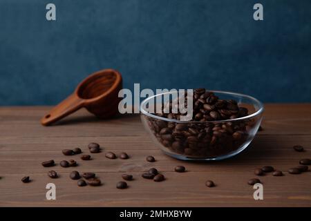 roasted coffee beans in glass bowl on table Stock Photo