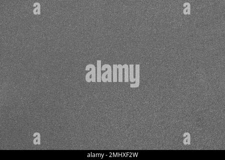 Gray abrasive paper close-up. Grainy texture. Stock Photo