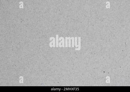 Grey background. Texture of gray recycled cardboard close-up. Stock Photo