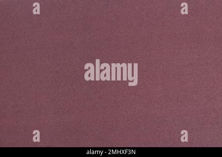 Brown-red sandpaper close-up. Grainy texture. Stock Photo